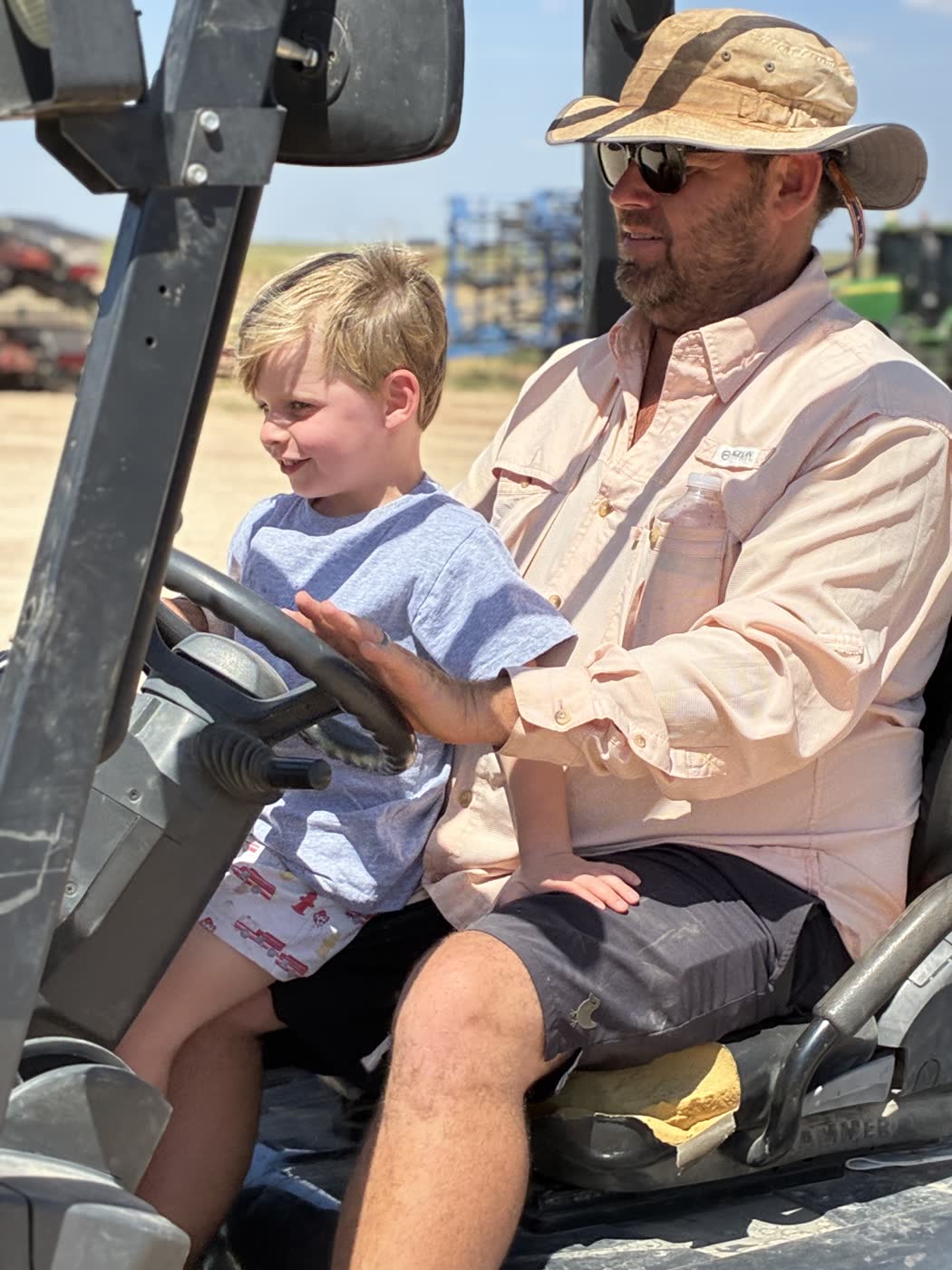 A man and a boy in a tractor